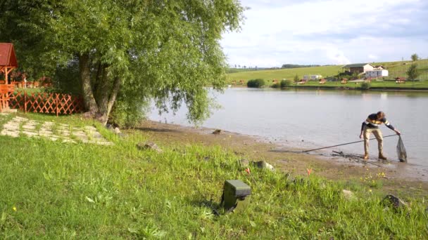 Angler Taking Fish Lakeside Landing Net — Wideo stockowe