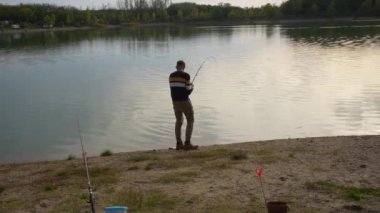 Angler fighting a fish near the lakeside