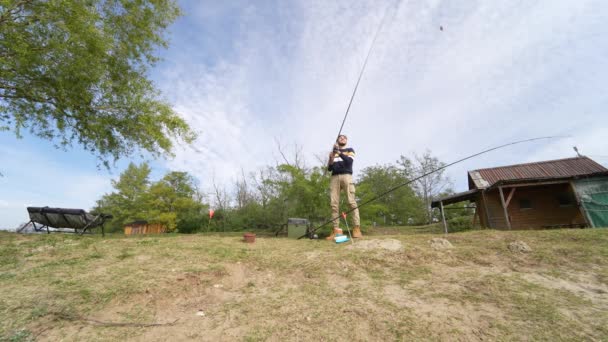 Angler Low Angle Casting His Rod Out — Video Stock
