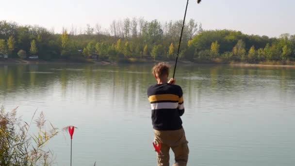 Angler Guy Casting Out His Rod Lakeside — Stock video