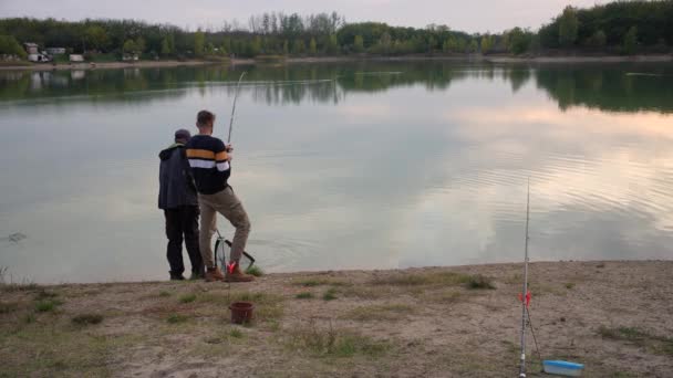 Two Anglers Pulling Out Fish Sunset Lake — Stok video