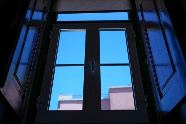 Window looking out towards the clear perfect blue sky