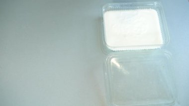 Pouring cereals into milk on a kitchen table