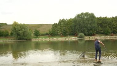 Landing a carp in a net and pulling it out