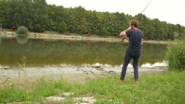 Angler Casting Puts His Rod — Stockvideo
