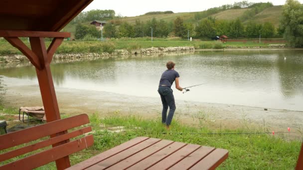Angler Casting Fishing Lake Leaves His Rod — Stok video