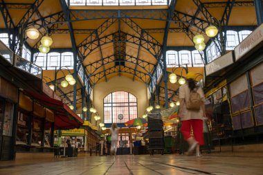 People passing inside a fancy old market hall