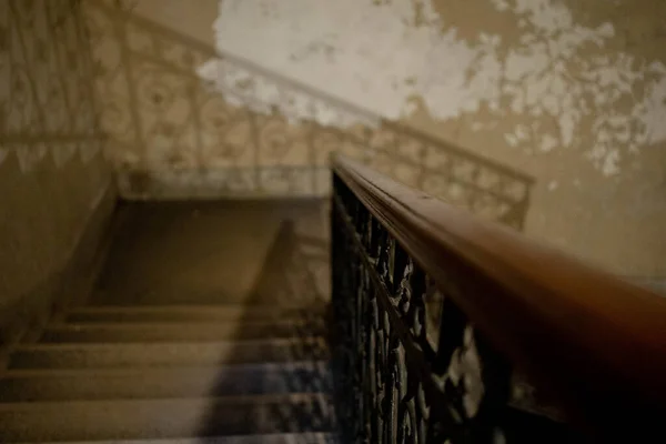 Stairs leading down next to a bannister