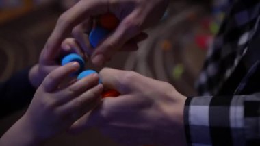 Father and son loading a nerf gun quickly with their hands