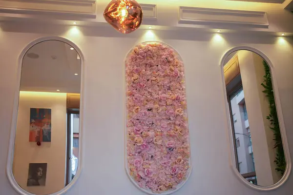 Fluffy flowery wall decoration and golden lights. High quality image