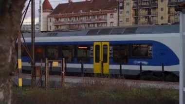Train passing at a station in sunset. High quality 4k footage