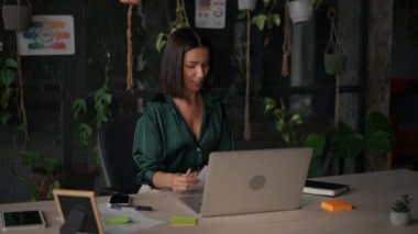 Happy young nice woman waving at laptop screen, holding video call meeting conversation, discussing working issues, passing job interview from home, distant communication concept