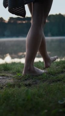 Close up of the man wearing swimsuit throwing towel from his shoulders at the ground while preparing swimming in the cold winter lake at morning. Cold water hardening