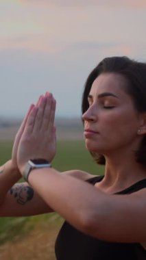 Abdominal breathing. Woman practicing belly breathing with namaste gesture for good relaxation. Breath awareness yoga exercise. Meditation for body, mind and emotions. Spiritual practice