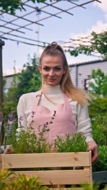 Positive Woman Botanist Holding Box Flowers Showing Camera Smile Greenhouse — Αρχείο Βίντεο