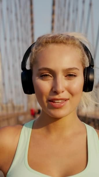 Portrait Blonde Sexy Sportswoman Listening Music Headphone Looking Camera Bridge — Stok Video