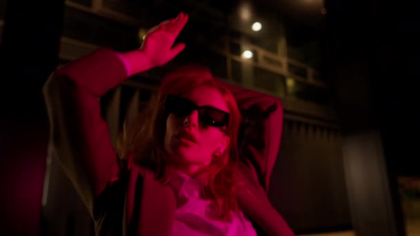 Stylowa Kobieta Modnym Garniturze Okularach Przeciwsłonecznych Patrząc Kamerę Taniec Neonowej — Wideo stockowe