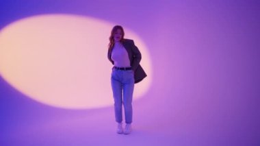 Güzel hippi kadın neon rengi arka planda dans ediyor. Modern moda kadın aylaklık ediyor. Gençler dans ediyor