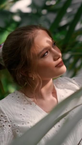 植物園の緑の木 草に囲まれた庭に立っている白いドレスを着た長い髪の美しい女性 自然と人々のコンセプト — ストック動画