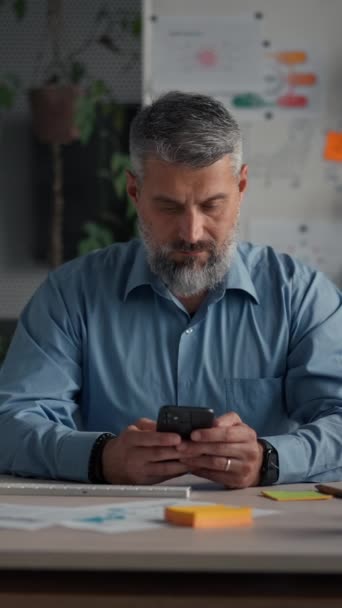 Serious Senior Businessman Wearing Smart Casual Shirt Using Smartphone Workplace — Stock Video