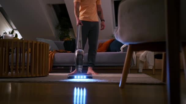 内部の掃除機が付いているカーペットを収容するジャニー クローズアップ 夜間の部屋やカーペットを掃除する未知の男の足 — ストック動画