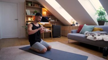 Atletik sporcu adam evde köpeğiyle yoga minderinde egzersiz yapıyor. Spor, spor ve sağlıklı yaşam tarzı konsepti