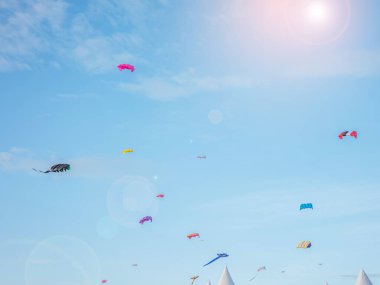 Rüzgarlı havada uçan renkli uçurtmalar avlunun önünde hobidir Satun, Tayland 'da Uçurtma Festivali' nde mavi bir gökyüzü