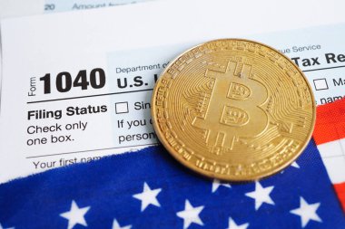 Tax form 1040 U.S. Individual Income Tax Return and bitcoin, business finance, Digital currency, Virtual cryptocurrency concept.