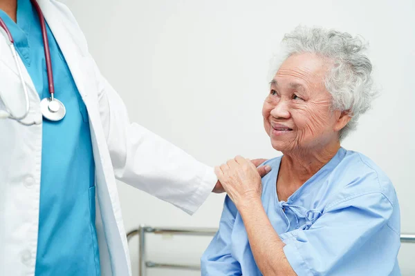 Doctor help Asian elderly woman disability patient in nursing hospital, medical concept.
