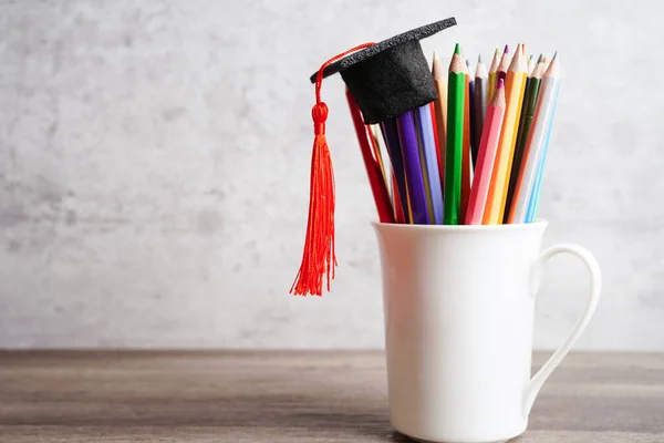 Colorful pencils in glass jar with copy space, learning university education concept.