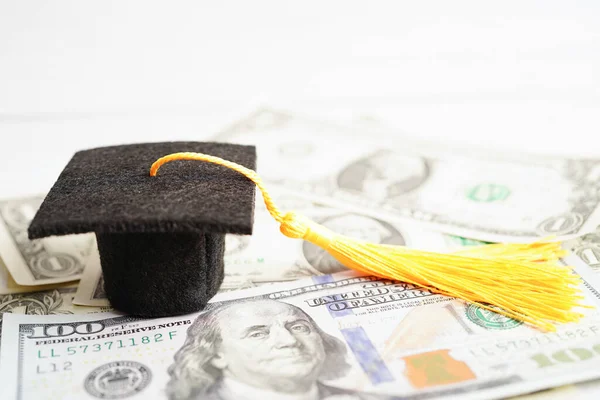 Graduation gap hat on US dollar banknotes money, Education study fee learning teach concept.