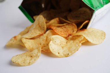 Potato chips in open bag, delicious BBQ seasoning spicy for crips, thin slice deep fried snack fast food in open bag.