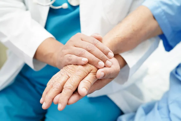 Stock image Doctor holding hands Asian elderly woman patient, help and care in hospital.