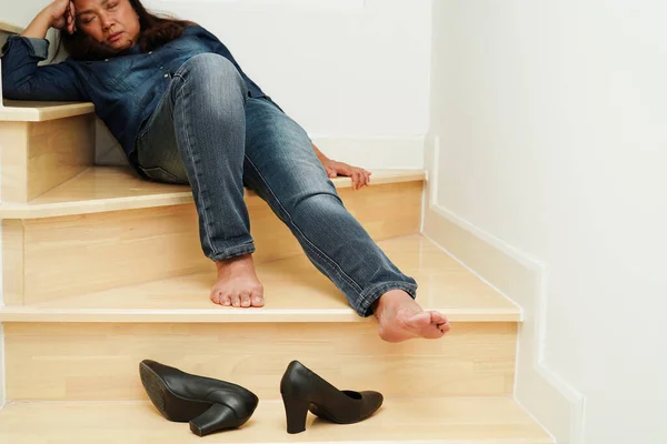 Asian business woman pain ankle, foot with leg cramp and fall down the stairs because slippery surfaces in office.