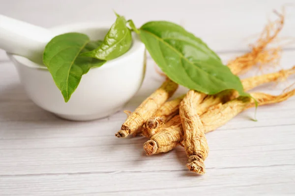 stock image Ginseng roots and green leaf, healthy food.