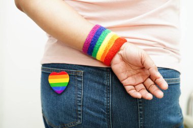 Asian woman with rainbow flag, LGBT symbol rights and gender equality, LGBT Pride Month in June.