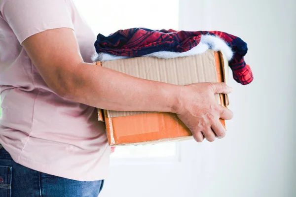 stock image Clothes donations in cardboard box for volunteer.