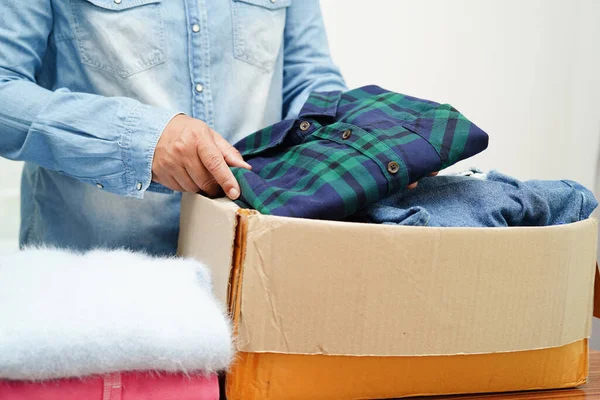 stock image Clothes donations in cardboard box for volunteer.