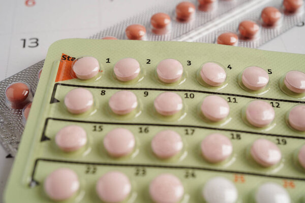 Birth control pills for female on calendar, ovulation day.