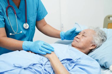 Doctor taking care, help and encourage Asian elder senior woman patient in clinic hospital.