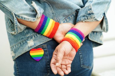 Asian woman with rainbow flag, LGBT symbol rights and gender equality, LGBT Pride Month in June.