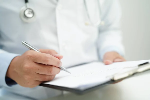 stock image Doctor checking and note diagnosis medicine in clipboard of patients in hospital.