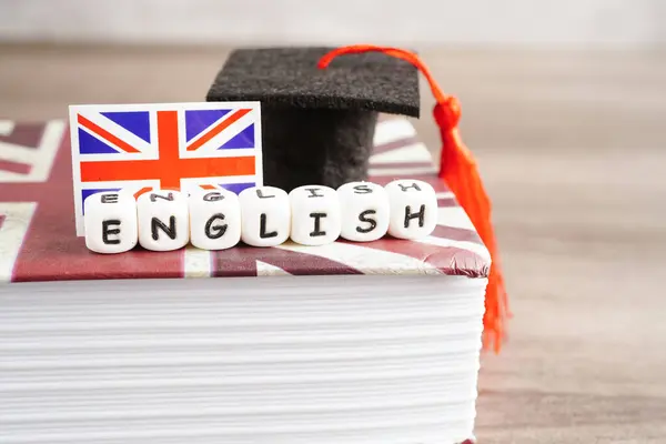English book with graduate hat, learning and tutorial for foreigner.
