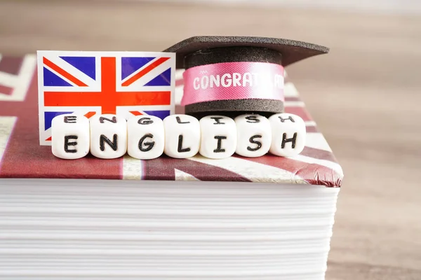 English book with graduate hat, learning and tutorial for foreigner.