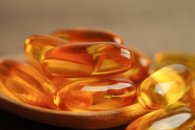 Fish oil or Cod liver oil gel in capsules with omega 3 vitamins, supplementary healthy food 