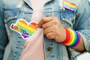 Asian woman with rainbow flag, LGBT symbol rights and gender equality, LGBT Pride Month in June.