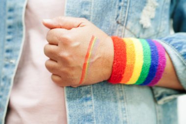 Asian woman with rainbow flag, LGBT symbol rights and gender equality, LGBT Pride Month in June.