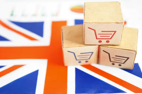 stock image Online shopping, Shopping cart box on United Kingdom flag, import export, finance commerce.