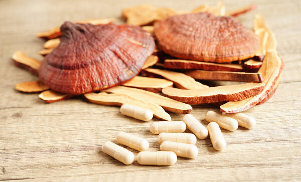 Lingzhi or Reishi mushroom with capsules, organic natural healthy food.