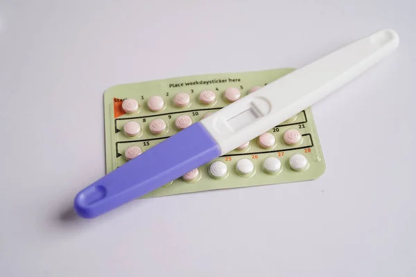 Pregnancy test with birth control pills for female of ovulation day, fetus, maternity, childbirth.